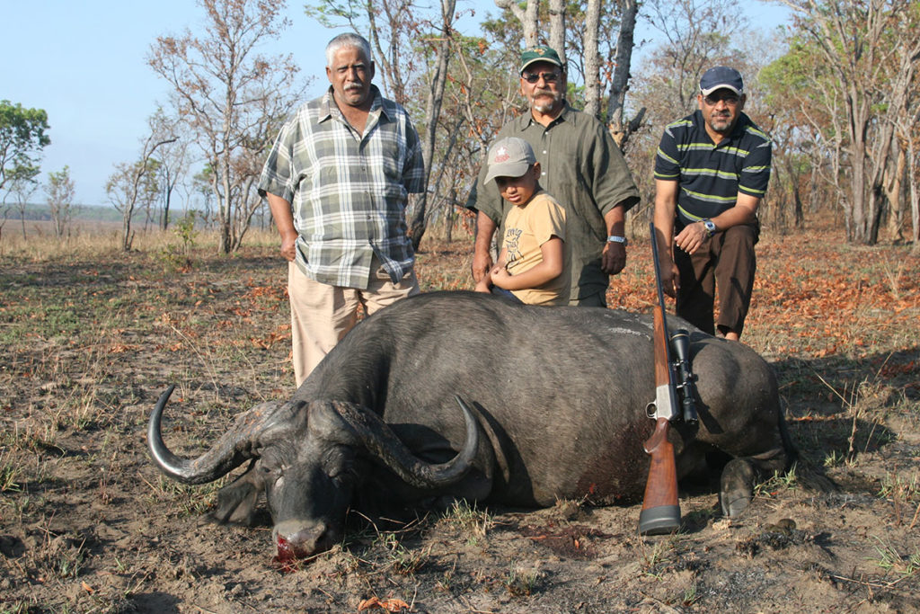 My father (center), his elder brother (left) and brother-in-law (right) on our last hunt together.  We drove to various points all morning and couldn’t find fresh sign.  On our way back, we saw tracks.  An hour of tracking and an hour more of approach, produced this fine bull for my father.  We had already diagnosed Alzheimer’s at this point and it was to be his final buffalo.  He guided me to my first, I to his last.  Lifetime experiences.